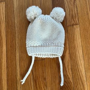 Knit cream hat with two Pom poms.